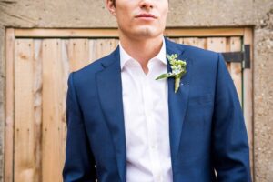 Groom in blue suit with corsage