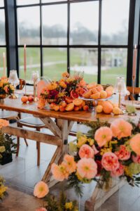 Wedding flowers in shades of orange decorating a table
