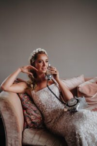 Bride on a settee using a silver phone