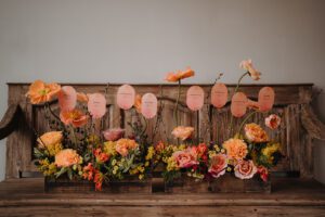 Wedding flowers and place cards in shades of orange